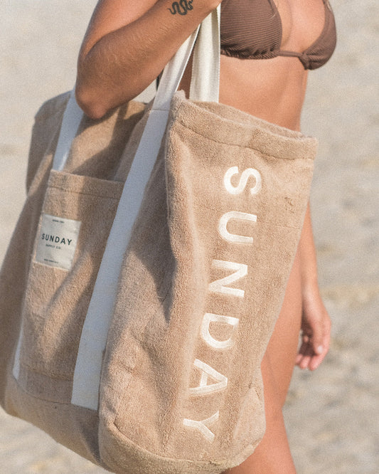 Terry towelling beach bag carried on the sand
