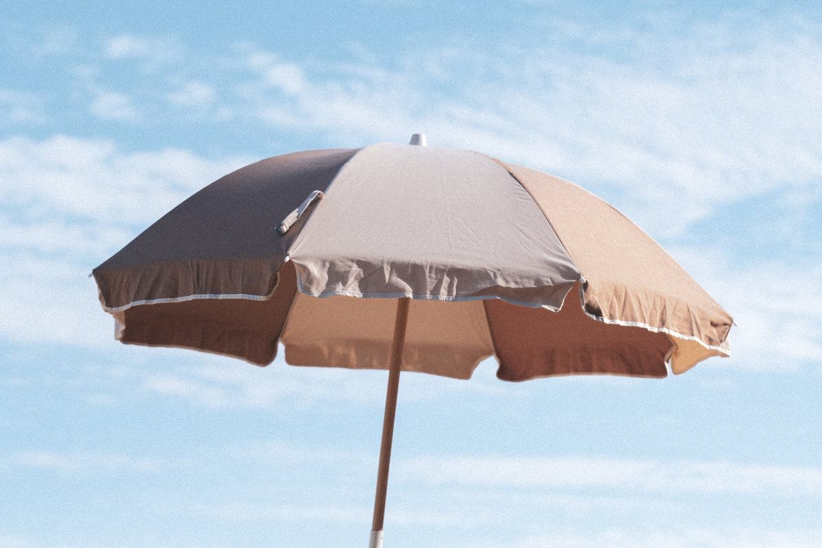 Husk Splice Beach Umbrella canopy and contrast trim against the sky